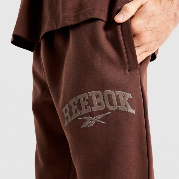 Spodnie dresowe męskie REEBOK SPODNIE PHILLIP VARSITY 100241203 kolor brązowy